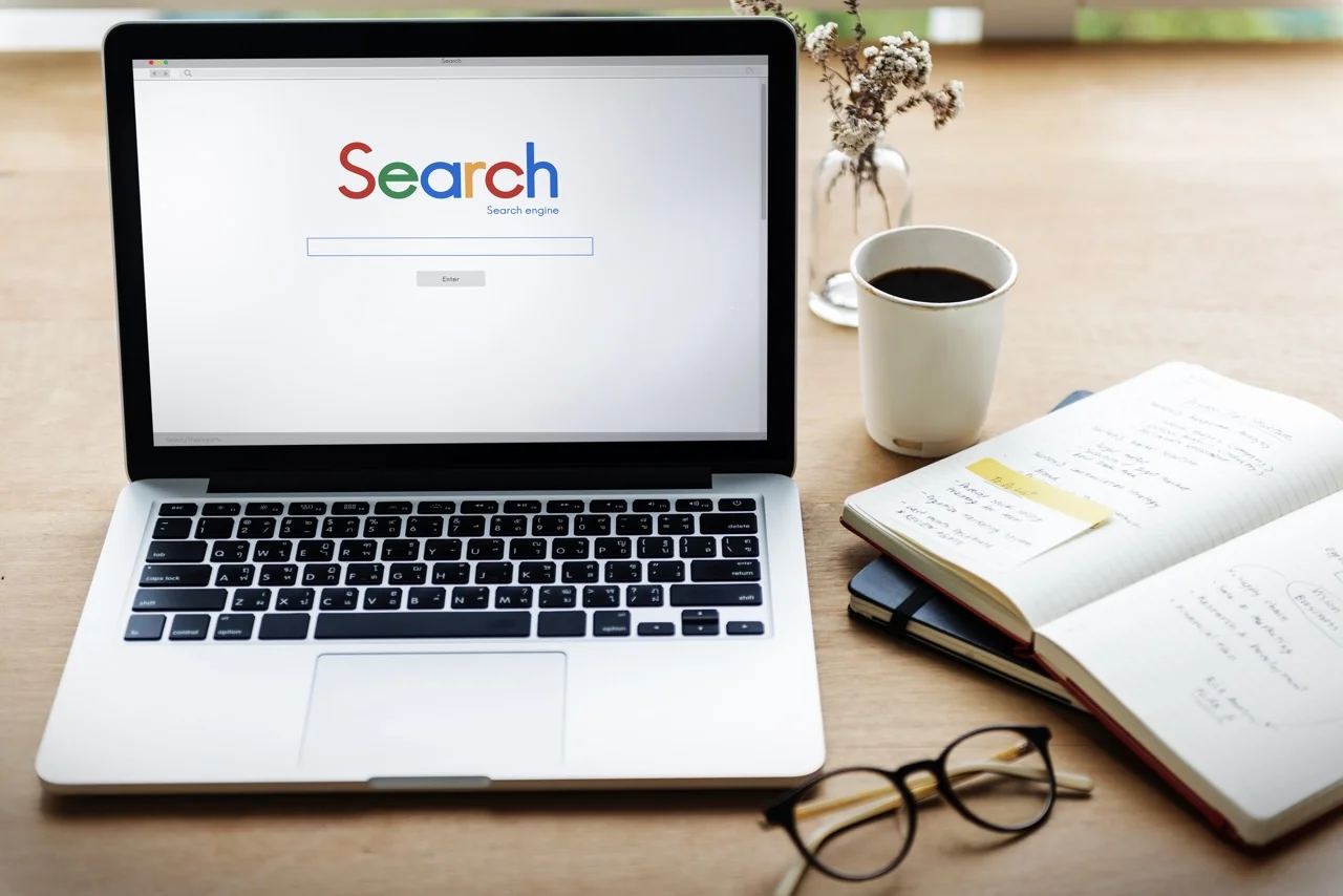 Search engine optimization workspace with laptop and notebook
