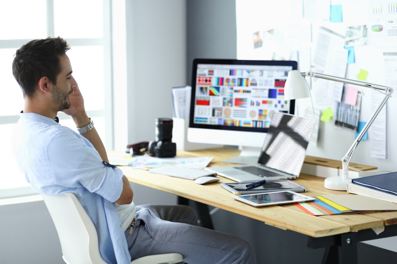 Web designer working on website design at modern workspace